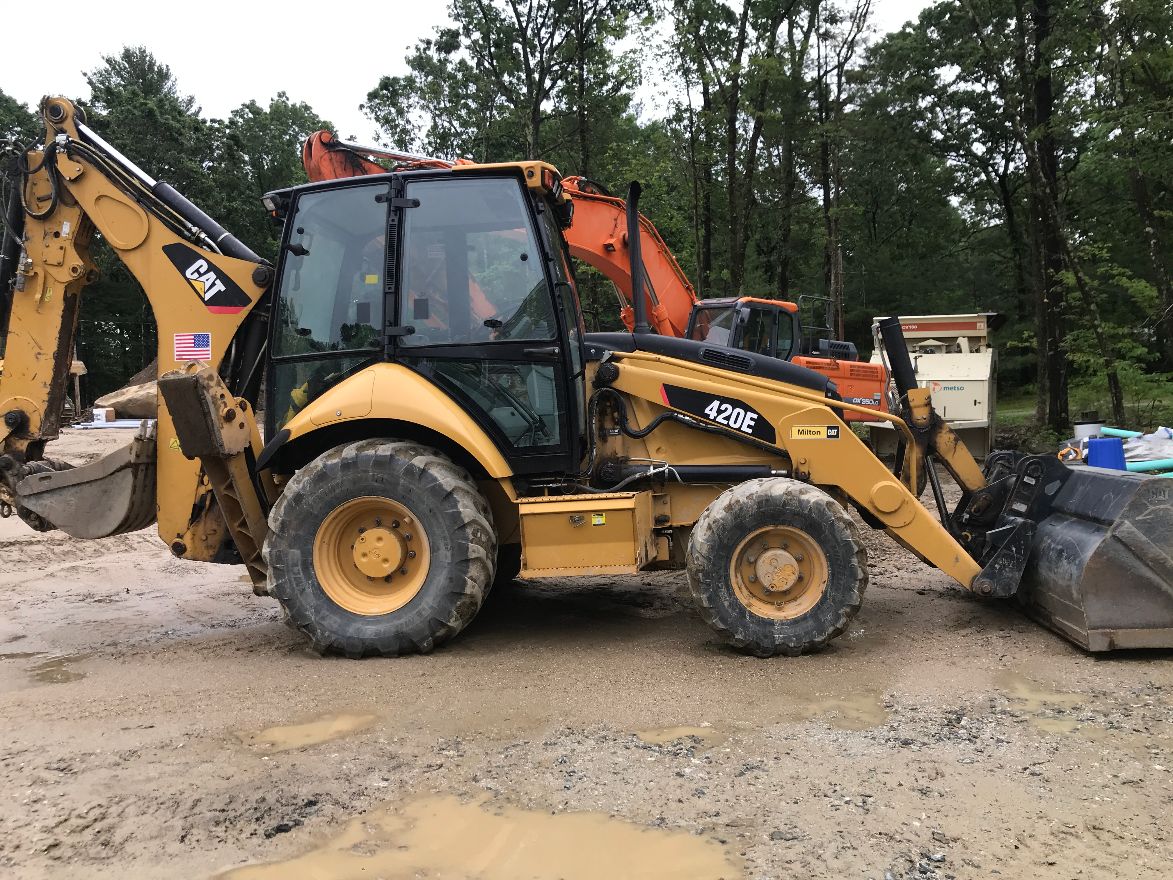 Yellow CAT front and backhoe loader